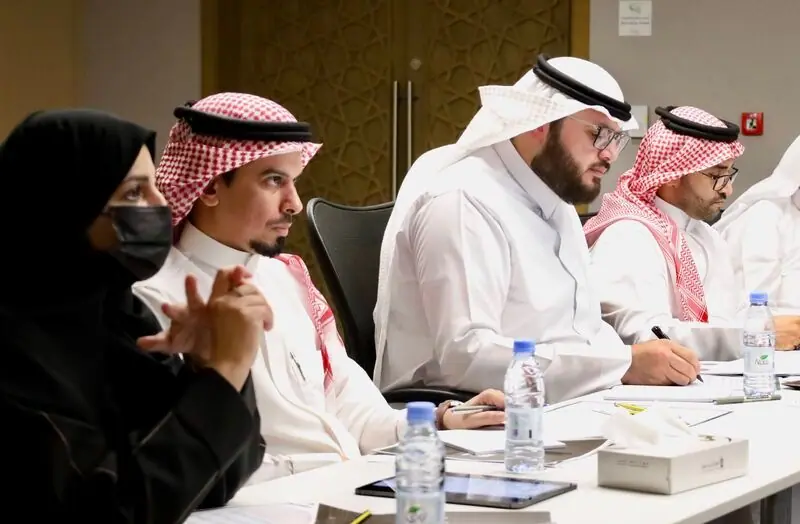 Jury members at the table taking notes